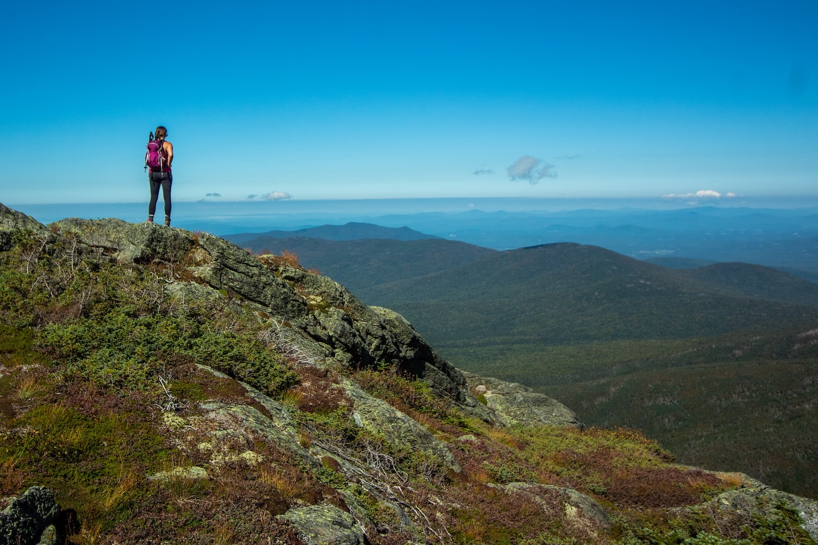 Discover the Best Hiking in New Hampshire This Summer 2 A woman enjoying the view on Mount Washington, one of the most popular places to go hiking in New Hampshire