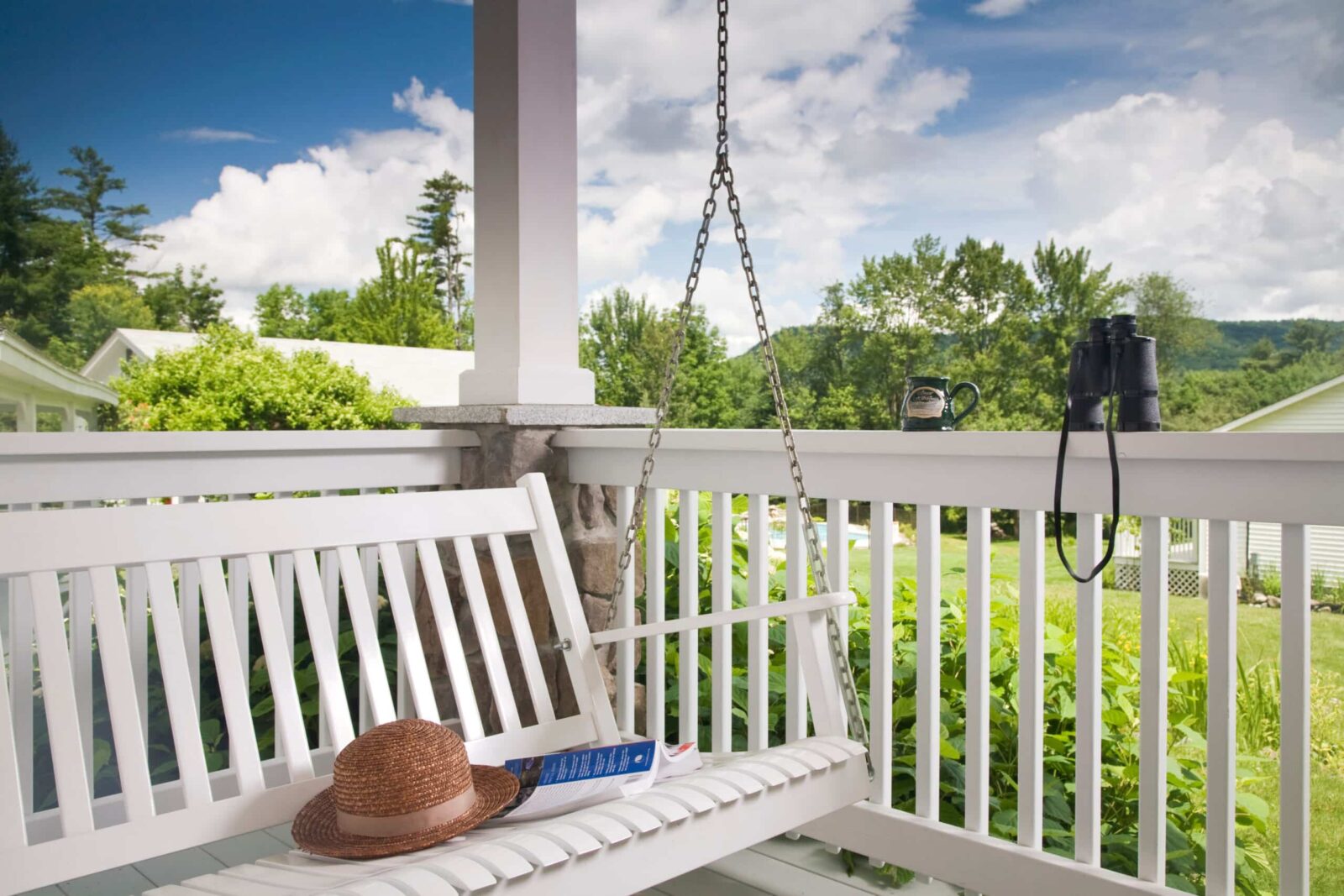 Your Guide to the Best of Franconia Notch State Park 2 Porch swing on the deck of the Dream Cottage at Sugar Hill Inn in New Hampshire.