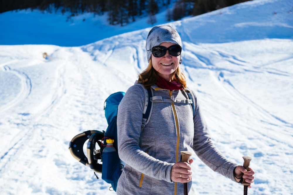 Hit the Snow at Great Glen Trails This Winter 1 Woman snowshoeing in places like Great Glen Trails in the White Mountains