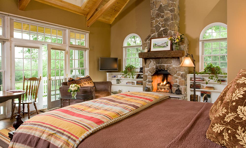 An inviting guest room with fireplace is the perfect place to enjoy winter getaways at our New Hampshire Bed and Breakfast