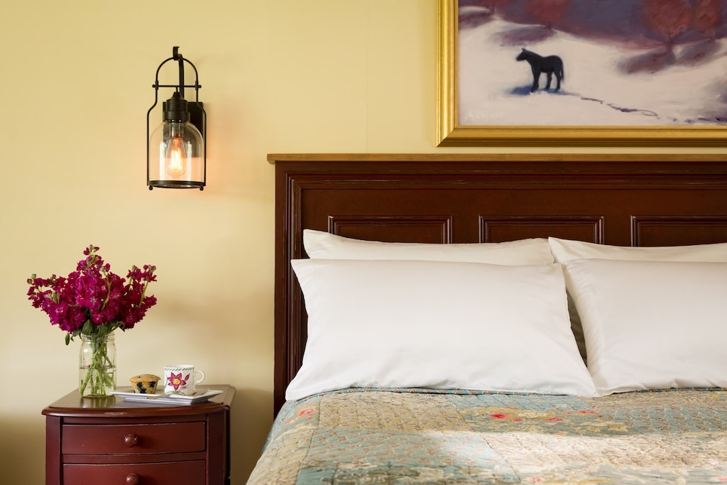 Amazing New Hampshire Ski Resorts Near Us 8 Stay at the best White Mountains Bed and Breakfast this winter! Enjoy this queen bed with beautiful flowers on the nightstand.