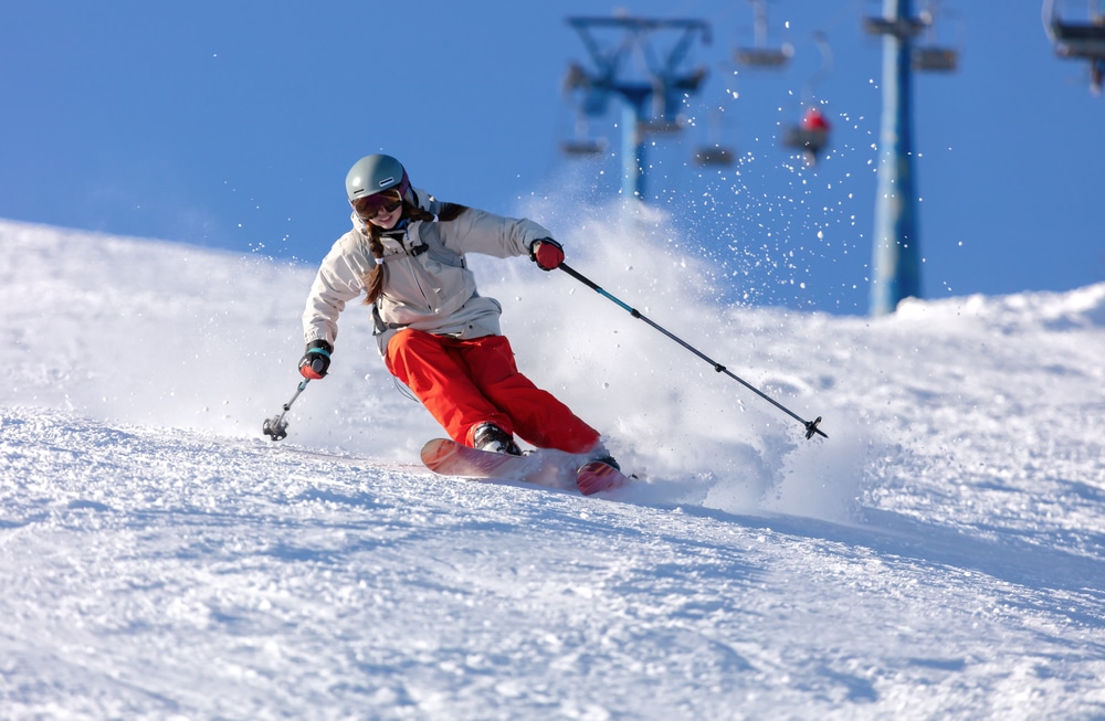 A girl downhill skiing at Cannon Mountain Ski Area and other New Hampshire Ski Resorts in the White Mountains