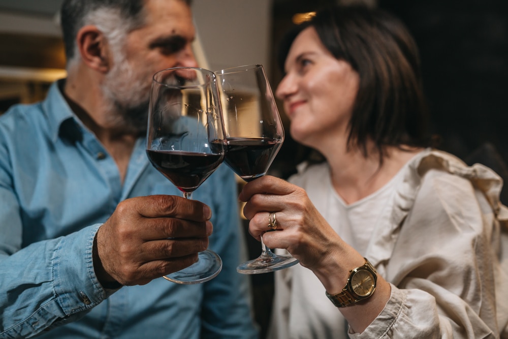 A couple enjoying a glass of wine during their romantic getaway at our Bed and Breakfast in New Hampshire