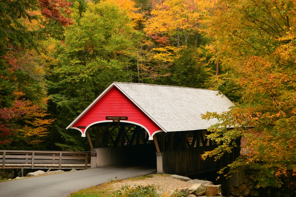 covered bridge surrounded by fall foliage - a great thing to do in New Hampshire after hiking the Artists Bluff Trail