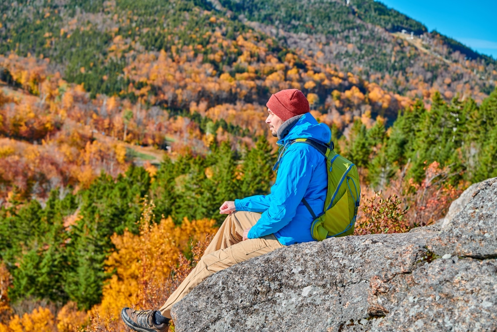 man gazing at the view from Artists Bluff Trail, the Best Franconia Notch Hike