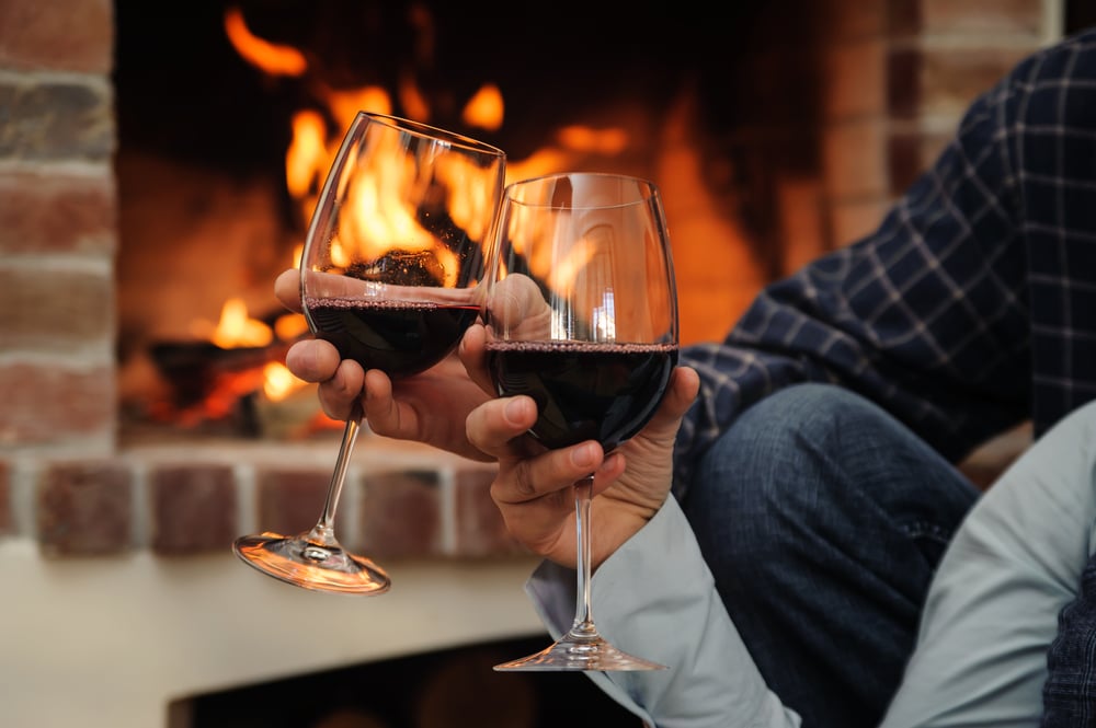 enjoying a glass of wine by the fire at our romantic New Hampshire Bed and Breakfast