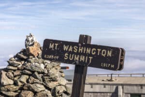 The sign and rocks at the summit of the Mount Washington Hike in New Hampshire