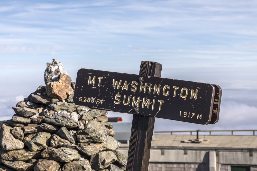 The sign and rocks at the summit of the Mount Washington Hike in New Hampshire
