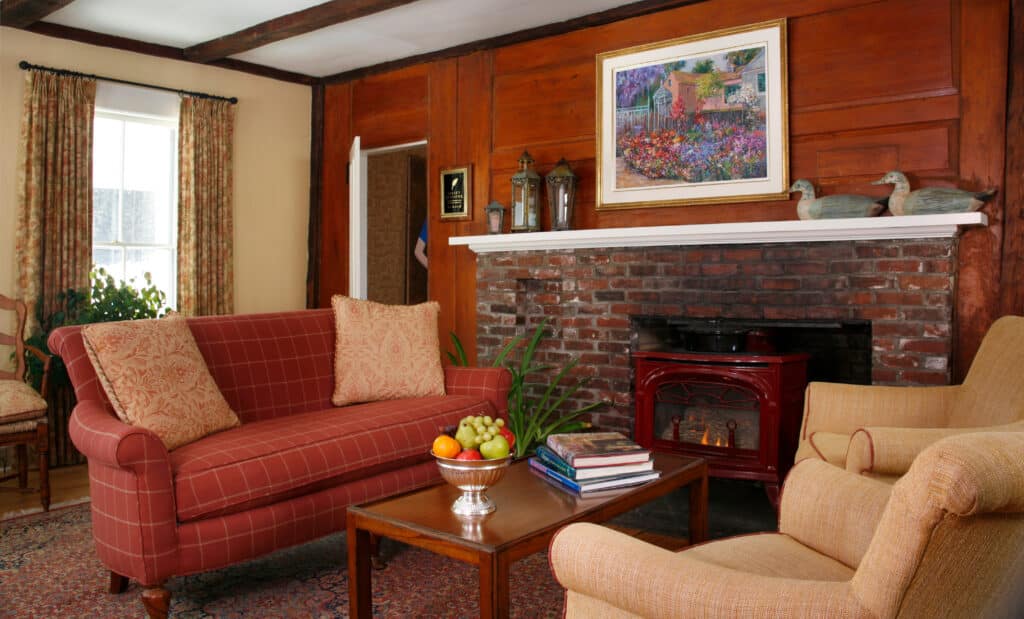Fall Foliage in New Hampshire: Best Time to Visit 8 One of the Best New Hampshire Inns. Sugar Hill Inn entryway. Fireplace and two couches.
